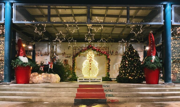 Torin Satakielilavan jouluasetelmassa valaistu lumiukko, havutonttuja, poroja ja valotäht