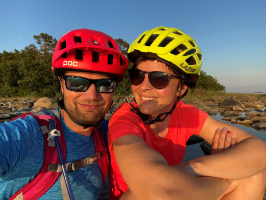 A man and a woman with bike helmets