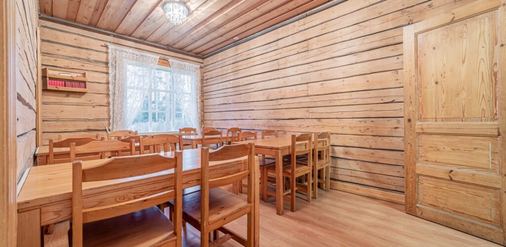 Log-walled room with chairs and tables