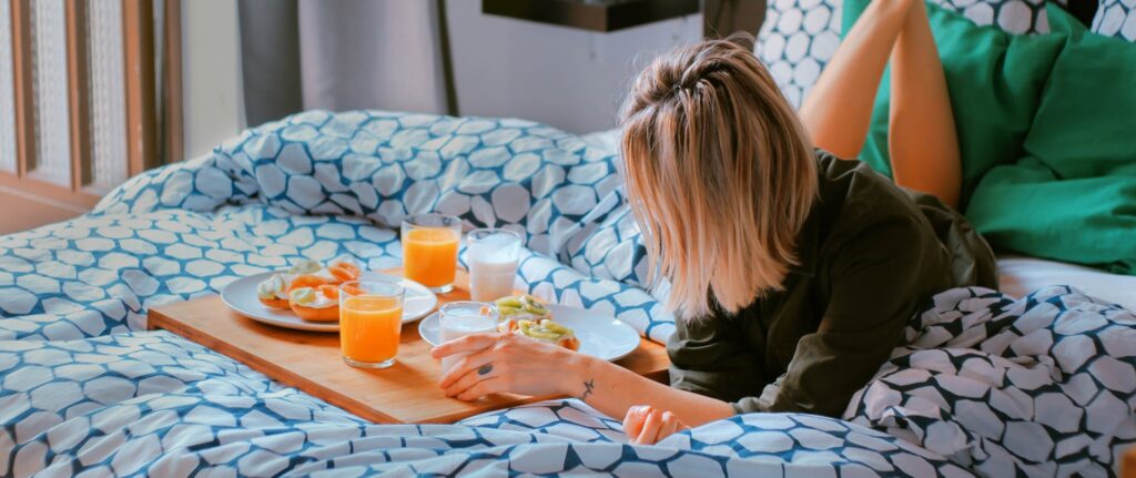 Person enjoying breakfast in bed