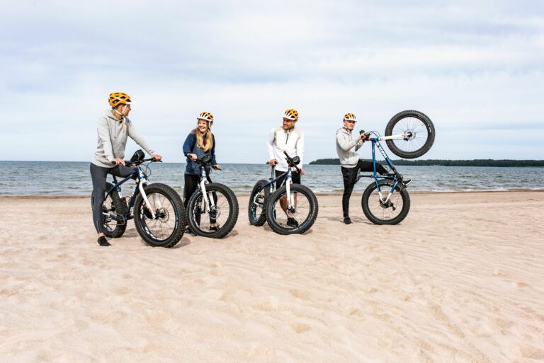 A family cycling on the beach